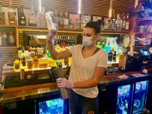masked bartender opening a bar